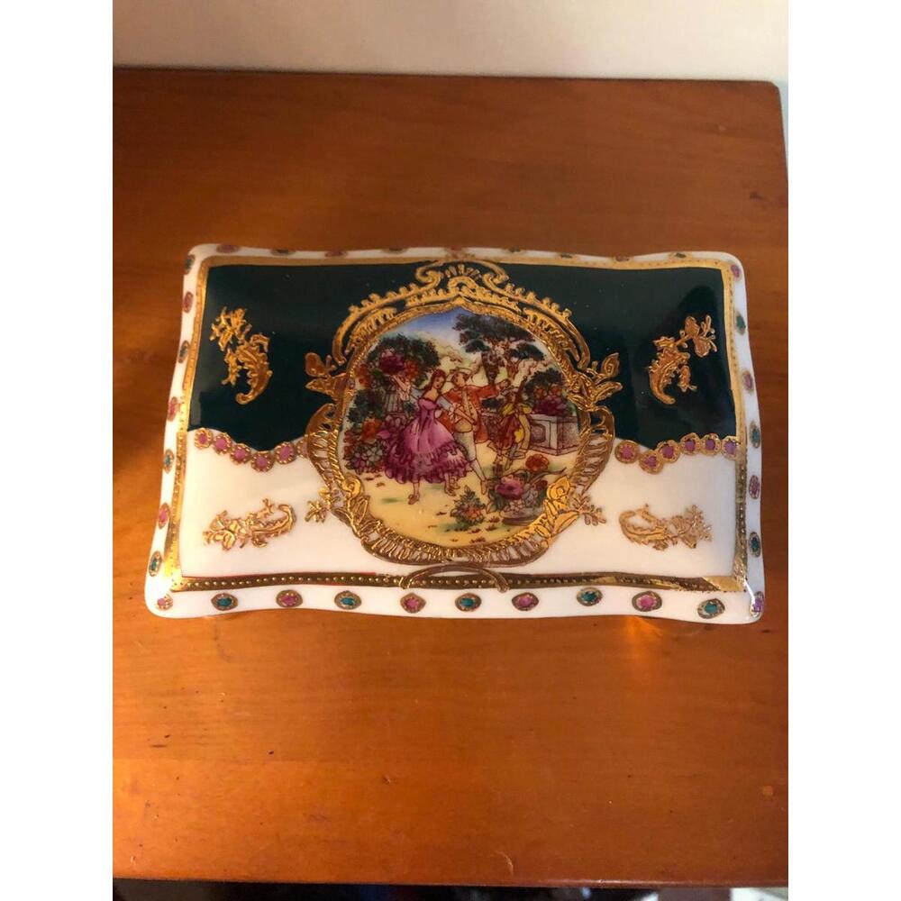 Limoges porcelain footed trinket box. Decorated with a classic Victorian scene